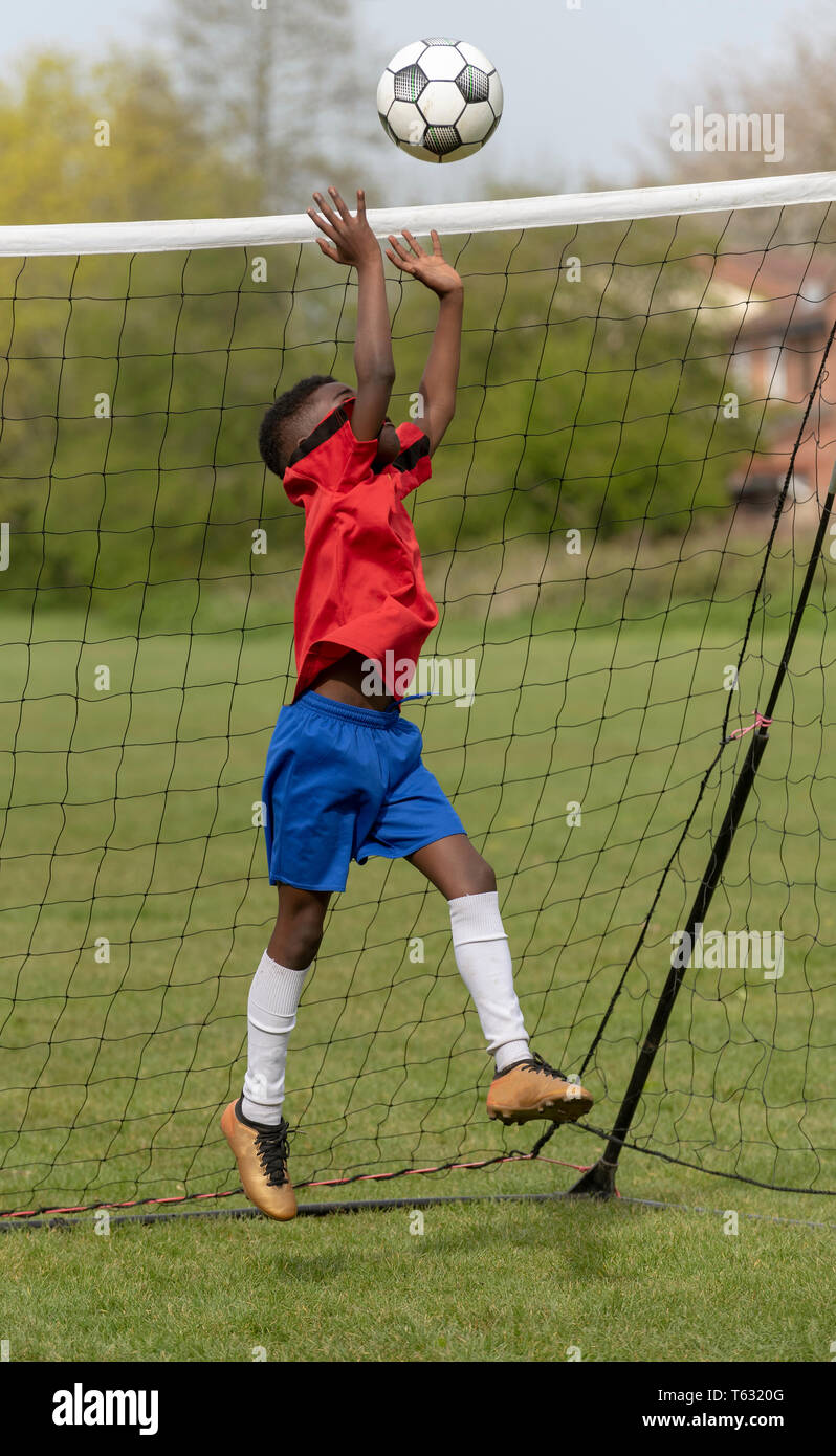 Hampshire, England, UK. April 2019. A young football player defending the goal during a traning session in a public park. Stock Photo