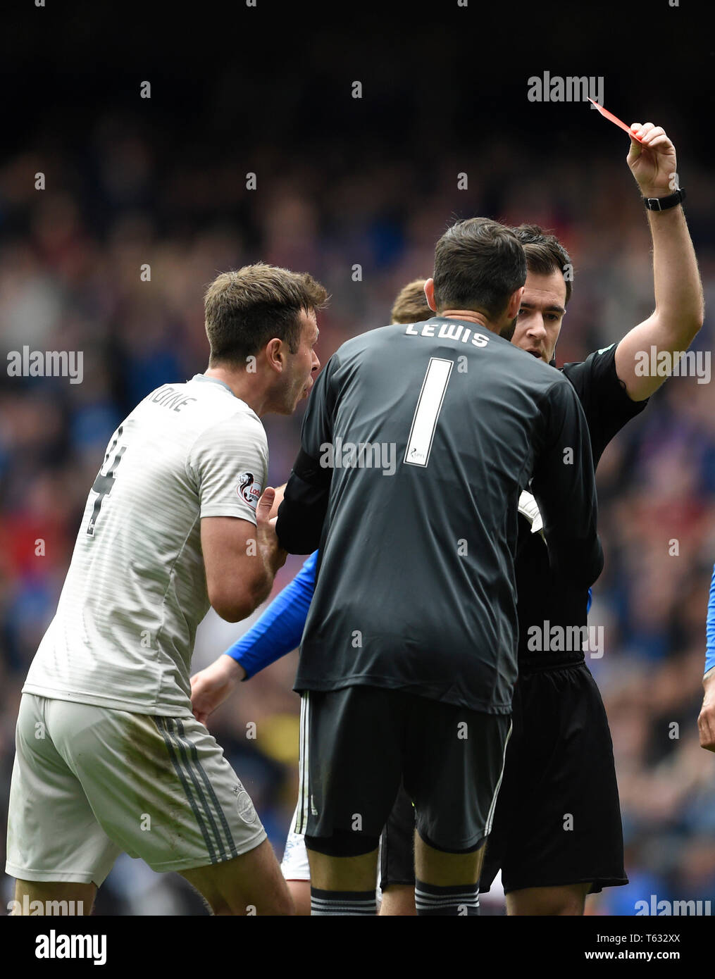 Referee David Robertson shows Aberdeen's Andrew Considine a red card after his challenge on