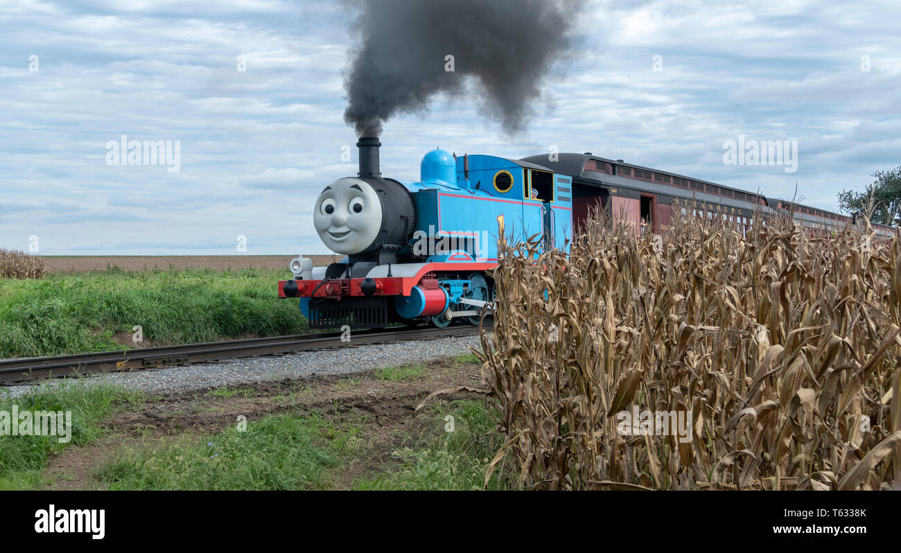 Strasburg, Pennsylvania - September 2018: Thomas the Train in Amish Countryside Puffing Smoke and Pulling Children Away Stock Photo