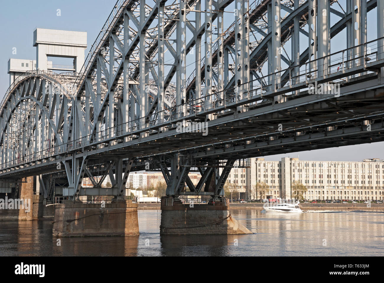 SAINT - PETERSBURG, RUSSIA – APRIL 26, 2019: Small white boat on The Neva River near The Finland Raiway Bridge in St Petersburg Stock Photo