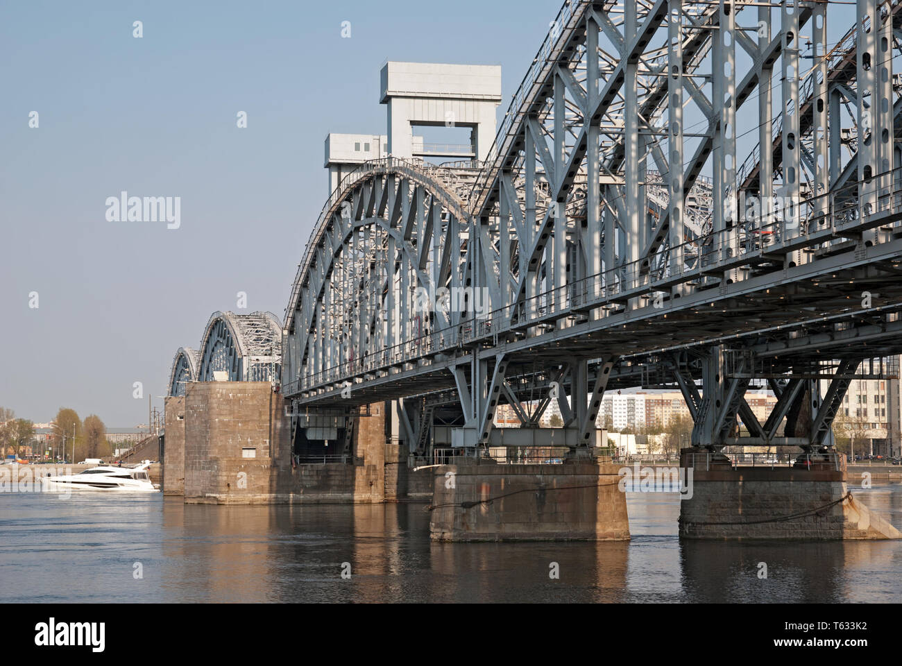 SAINT - PETERSBURG, RUSSIA – APRIL 26, 2019: Small white boat on The Neva River near The Finland Raiway Bridge in St Petersburg Stock Photo