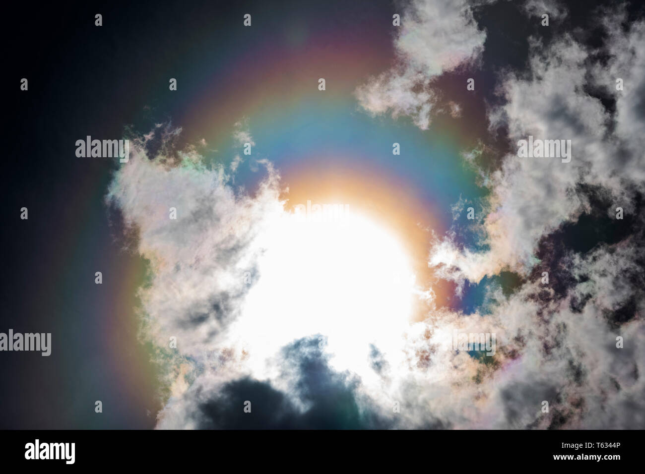 Refraction creates a rainbow, halo, or 'sundog' around the sun; Central Colorado; USA Stock Photo