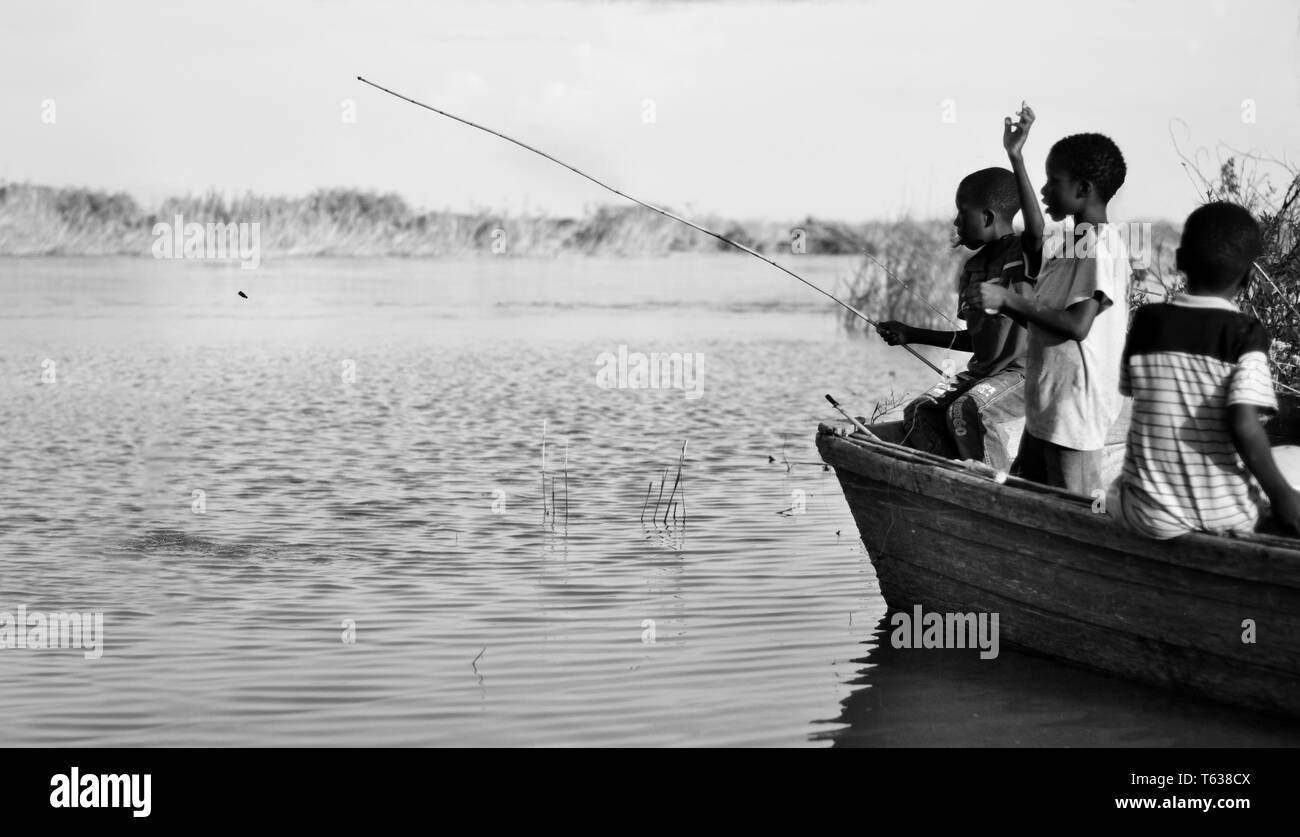 African kids fishing Stock Photo - Alamy