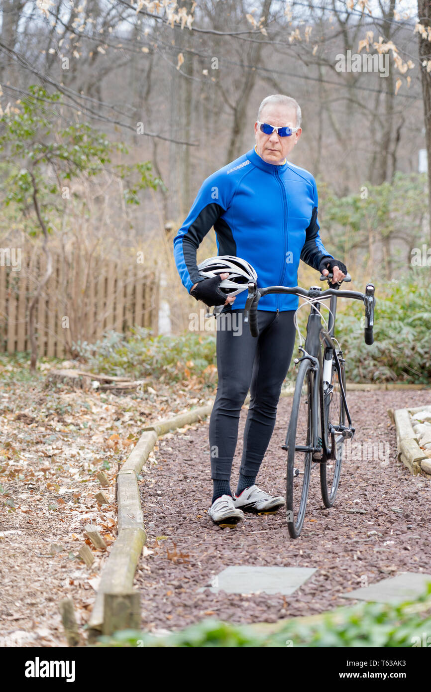 Older man riding bike in hi res stock photography and images