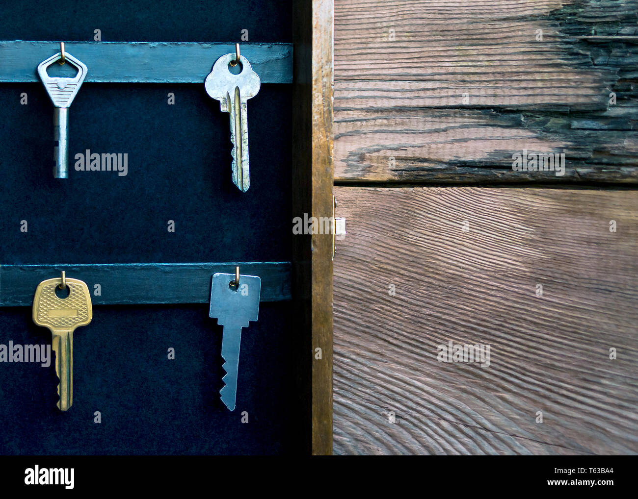 Keys Hanging On Golden Hooks In A Wall Key Holder On Rustic Wooden