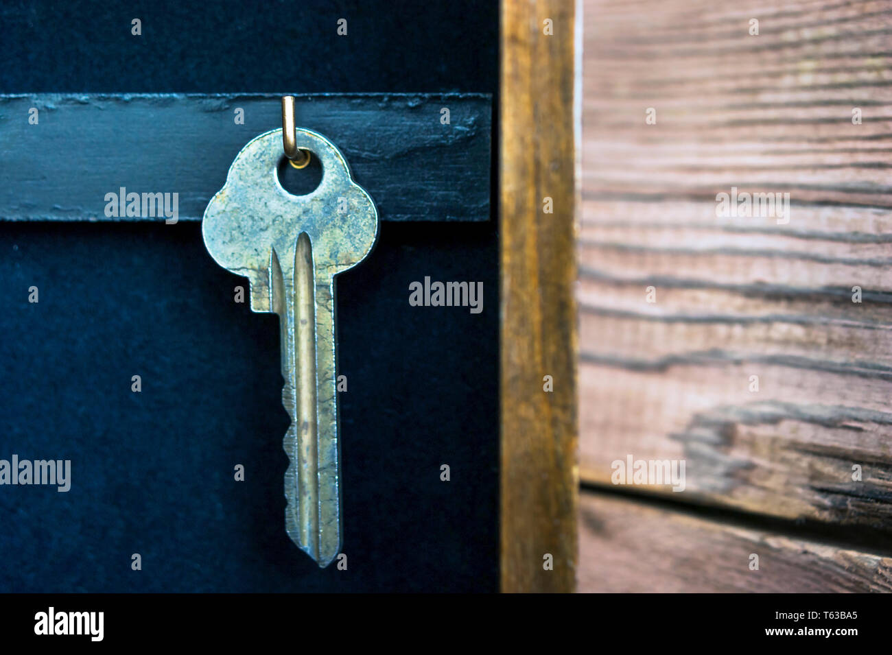 A Key Hanging On A Golden Hook In A Wall Key Holder On Rustic