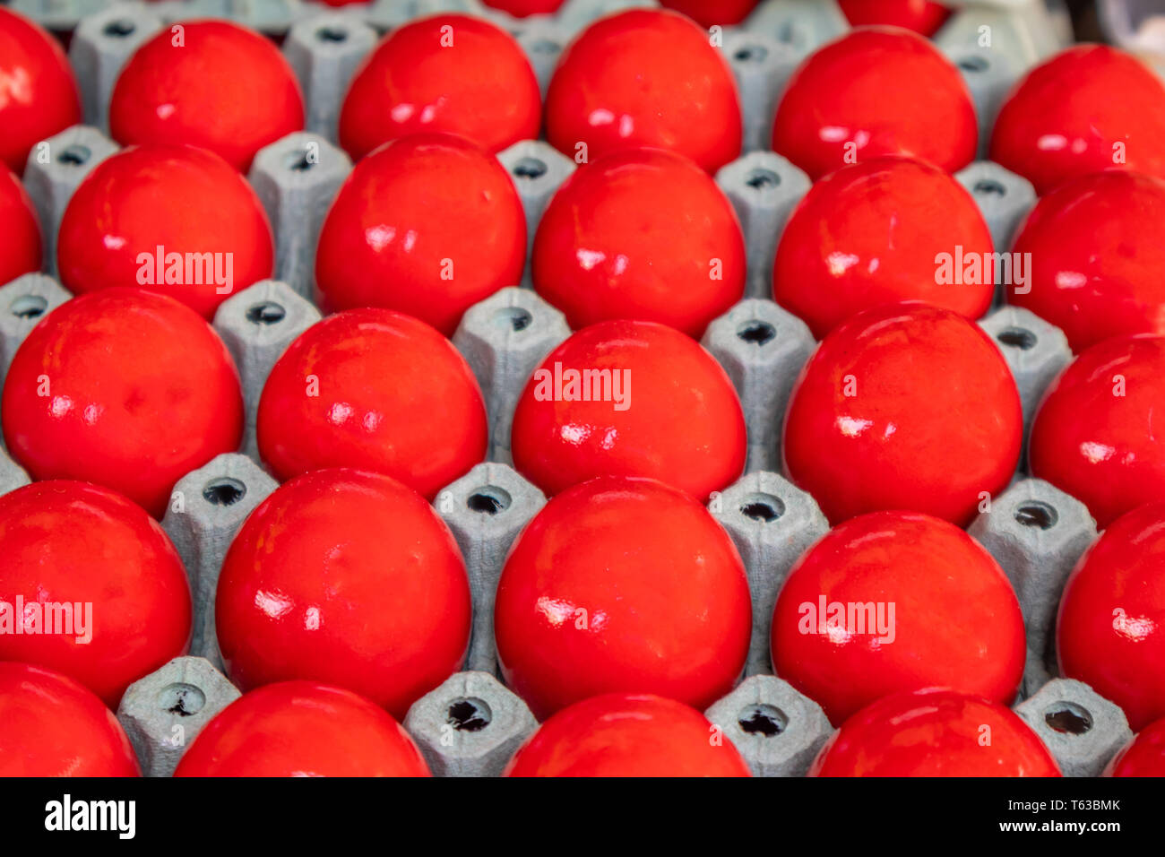 Orthodox Easter. Red eggs in carton packaging, closeup view, full background Stock Photo