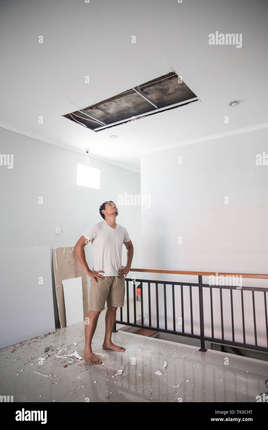 Man Looking Up The Broken Ceiling Stock Photo Alamy