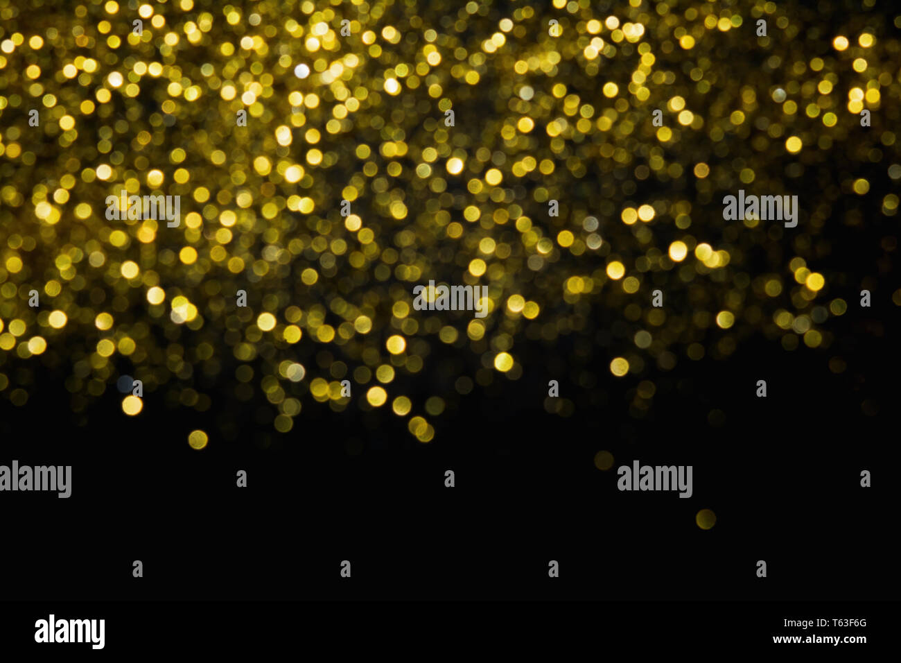 Abstract blurred glitter bokeh background in gold, on black Stock Photo ...