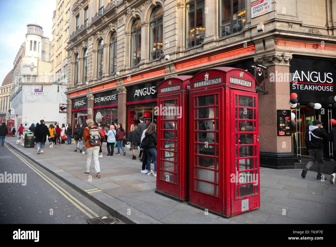 Traditional British Red Telephone Boxes by Angus Steakhouse,  Westend, London, England, UK Stock Photo