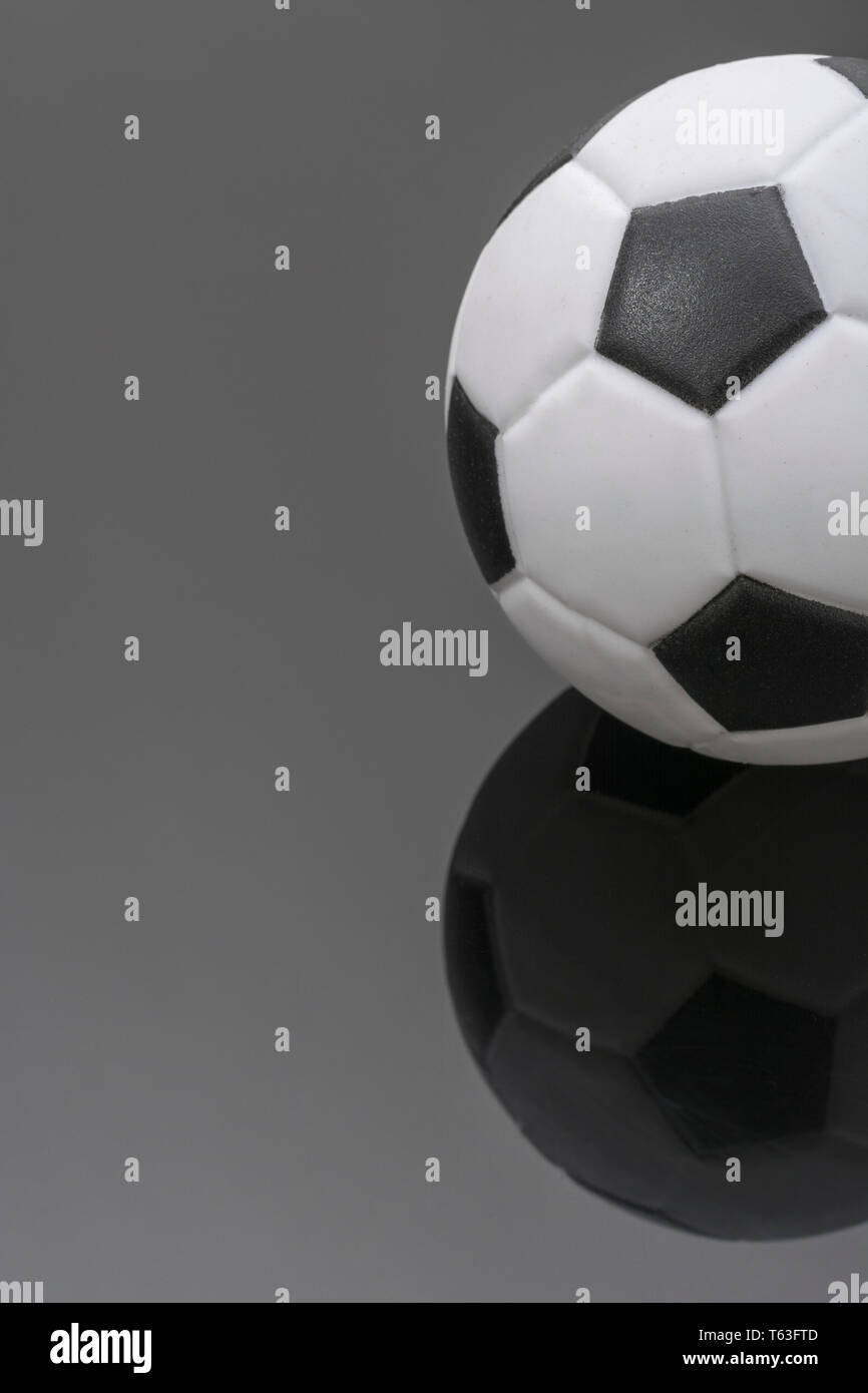 Kid's small plastic soccer ball (made in China) against dark background