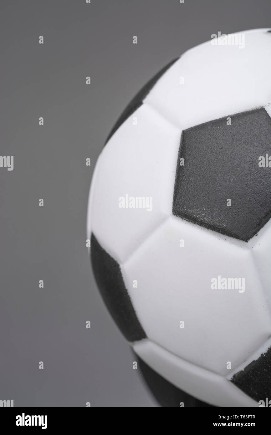 Kid's small plastic soccer ball (made in China) against dark background