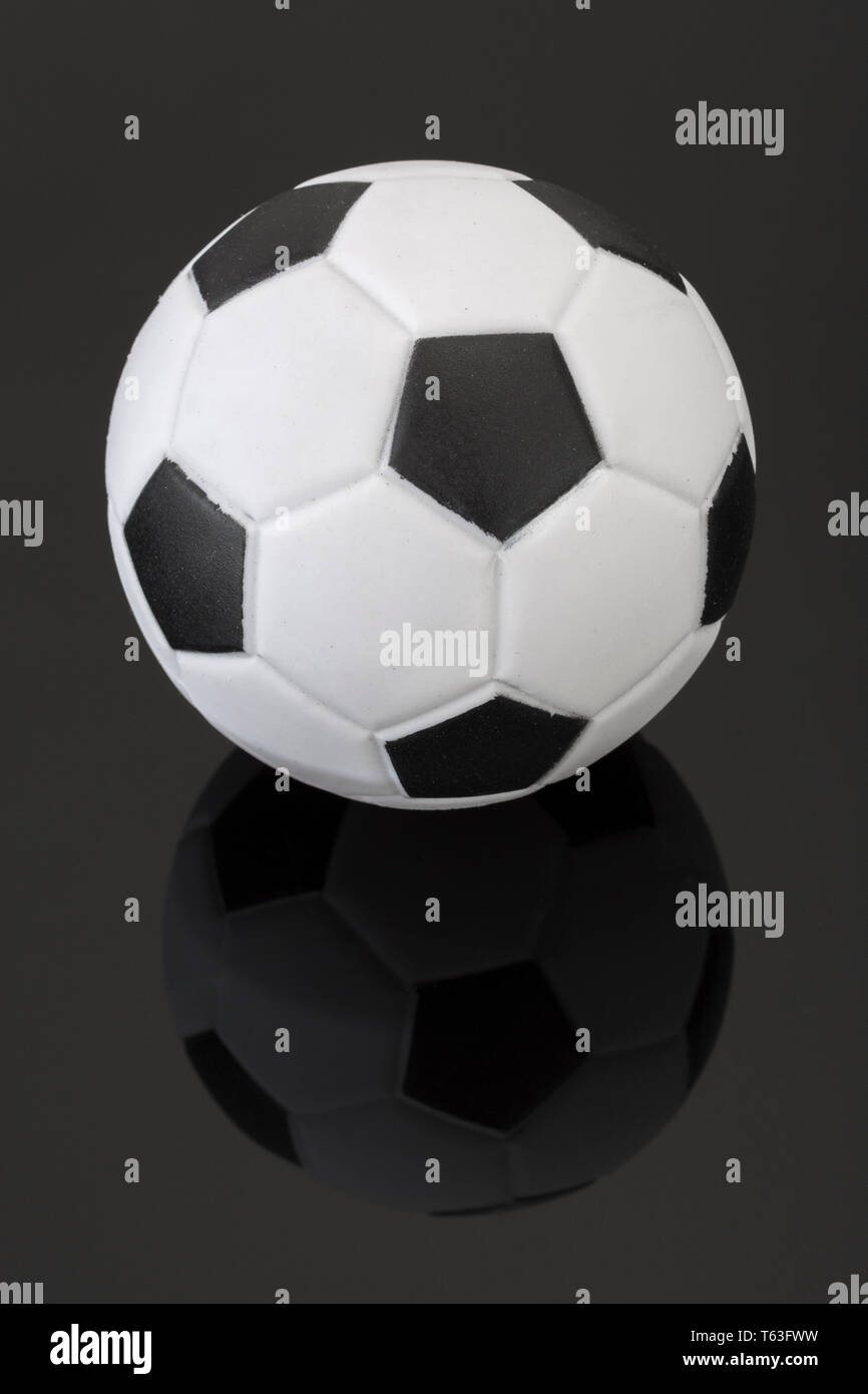 Kid's small plastic soccer ball (made in China) against dark background