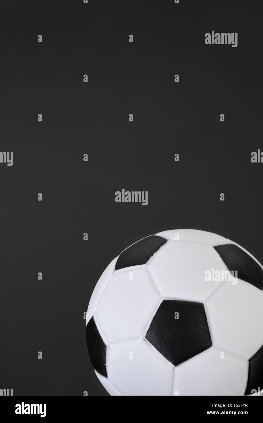 Kid's small plastic soccer ball (made in China) against dark background