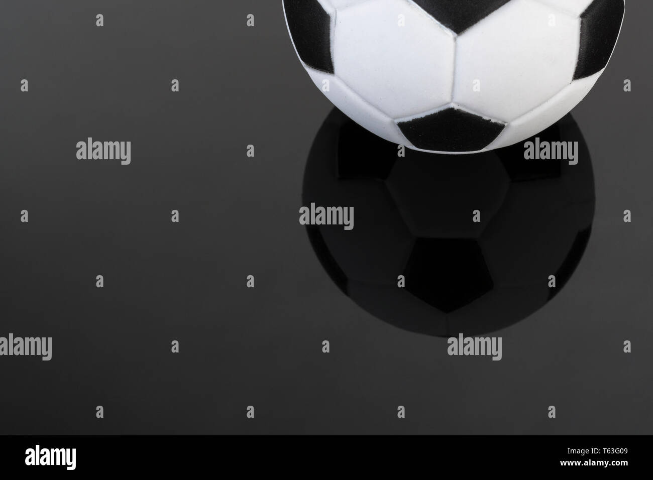 Kid's small plastic soccer ball (made in China) against dark background