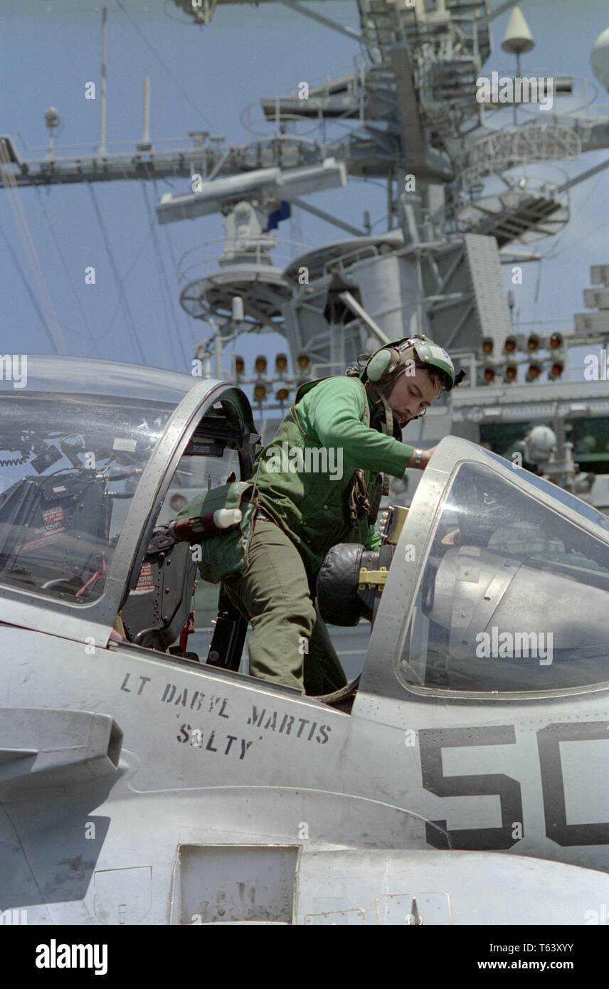 1st November 1993 A 'Green Shirt' sailor squeezes into the cockpit of an A-6E Intruder to carry out routine maintenance on the flight deck of the U.S. Navy aircraft carrier USS Abraham Lincoln in the Indian Ocean, 50 miles off Mogadishu, Somalia. Stock Photo