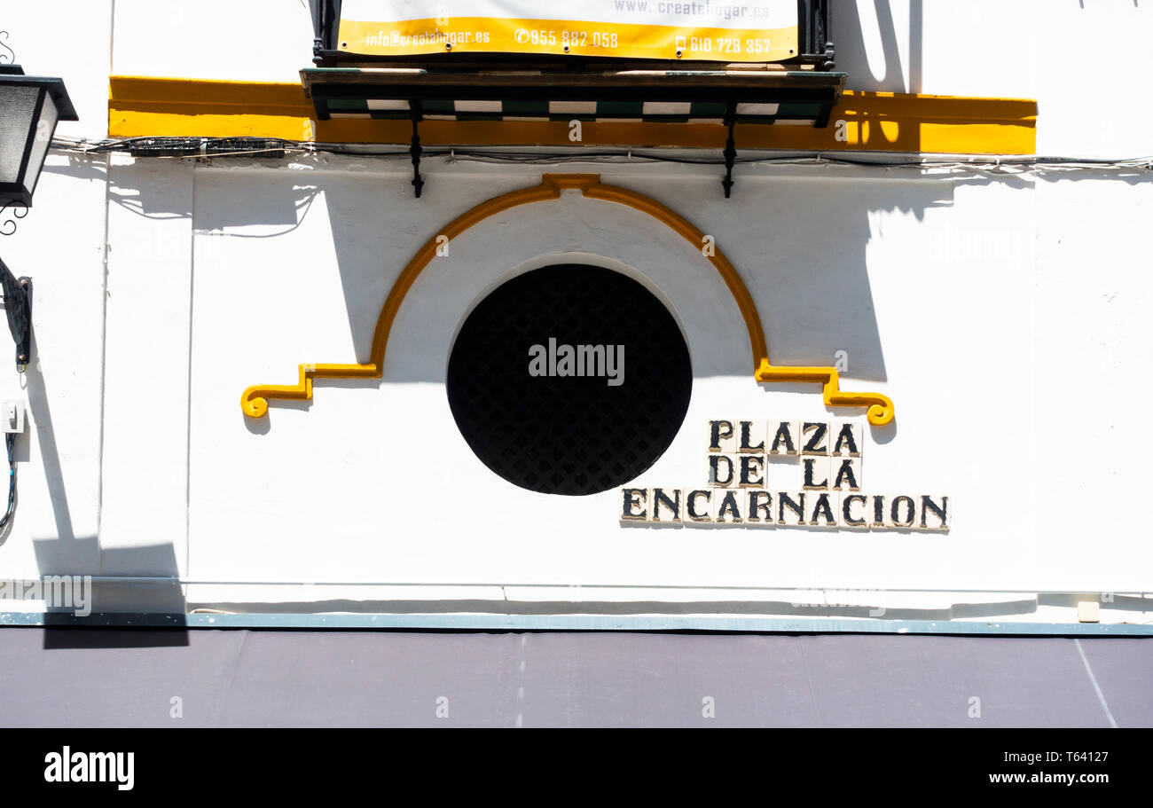 The Plaza de la Encarnacion location sign on the side of a building in Seville Stock Photo