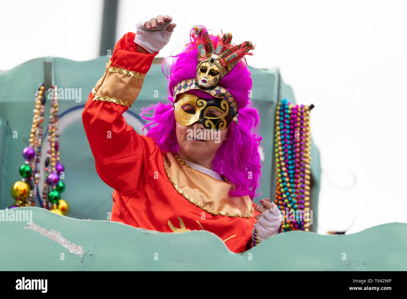 New Orleans, Louisiana, USA - February 23, 2019: Mardi Gras Parade, Woman wearing traditional clothing, throwing beads to the spectators during the ma Stock Photo