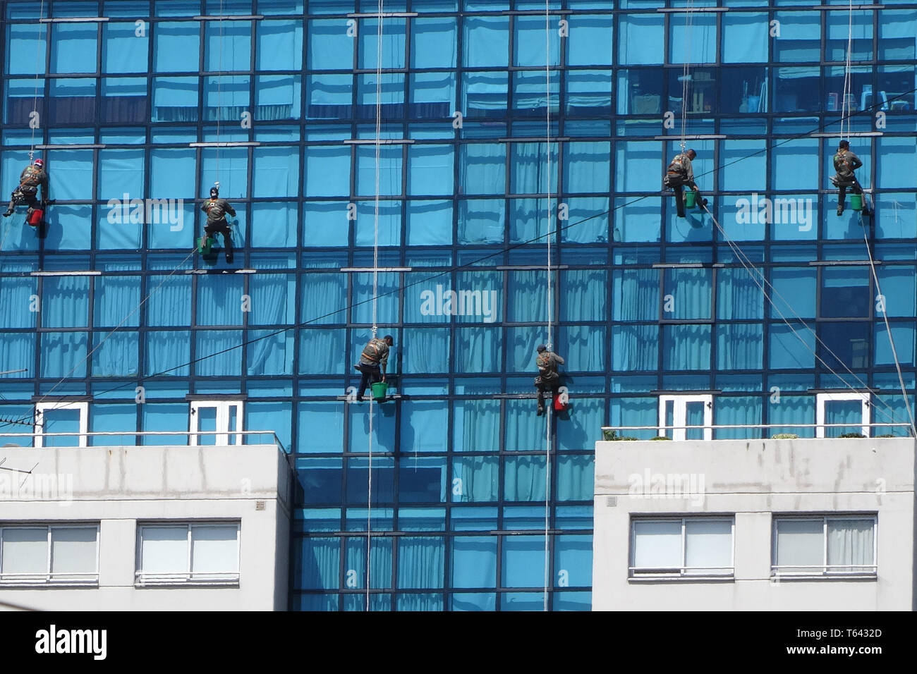 window cleaning on a high rise, dangerous job hanging on a rope vertically Stock Photo Alamy