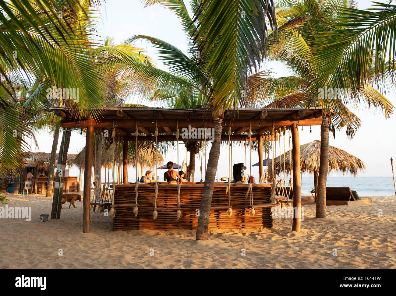 Beach bar with lush palms. Zipolite, Oaxaca State, Mexico. Apr 2019 Stock Photo