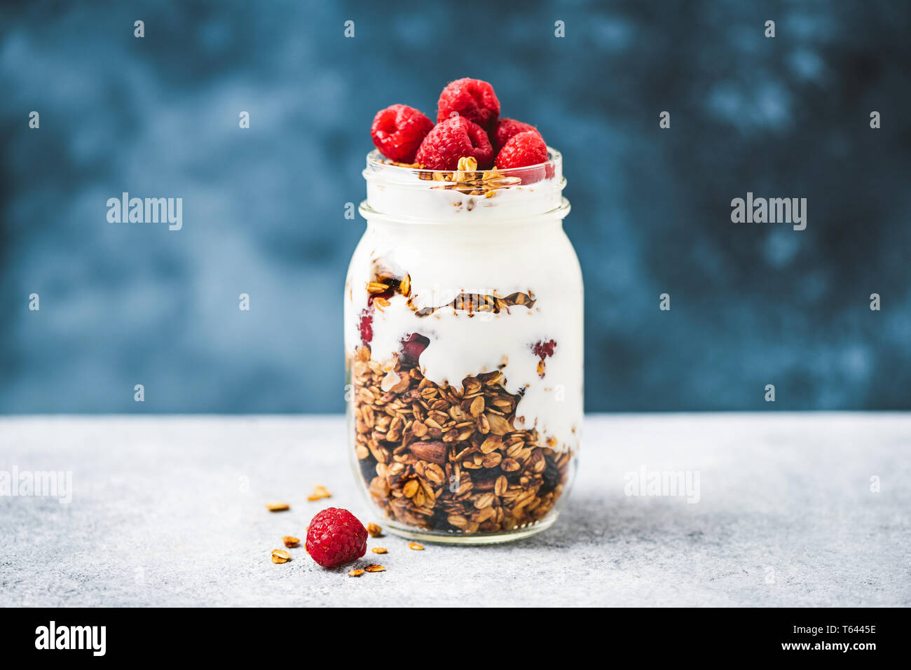 Granola with greek yogurt and raspberries in jar, healthy food, healthy eating concept Stock Photo