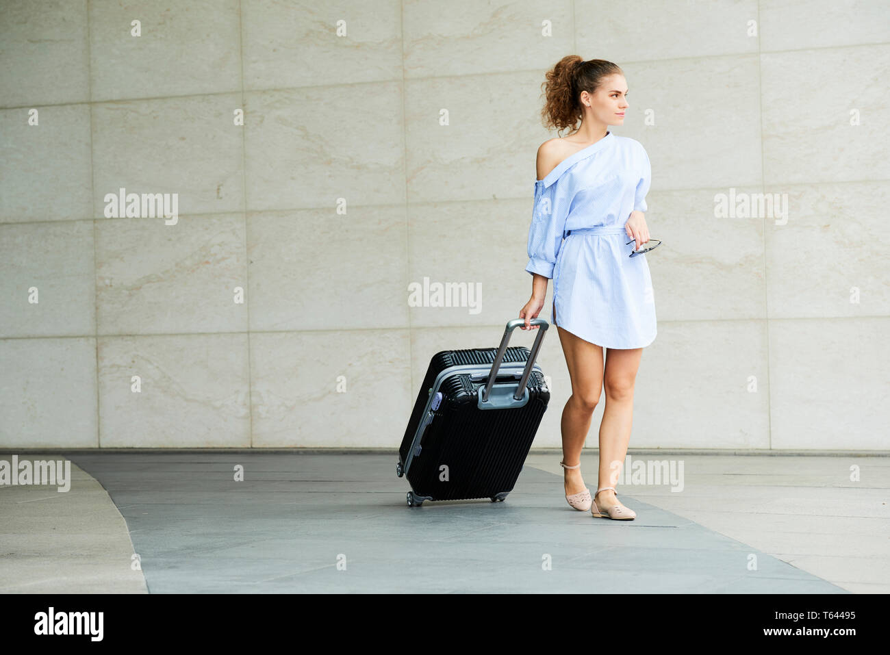 Woman traveling with big suitcase Stock Photo Alamy