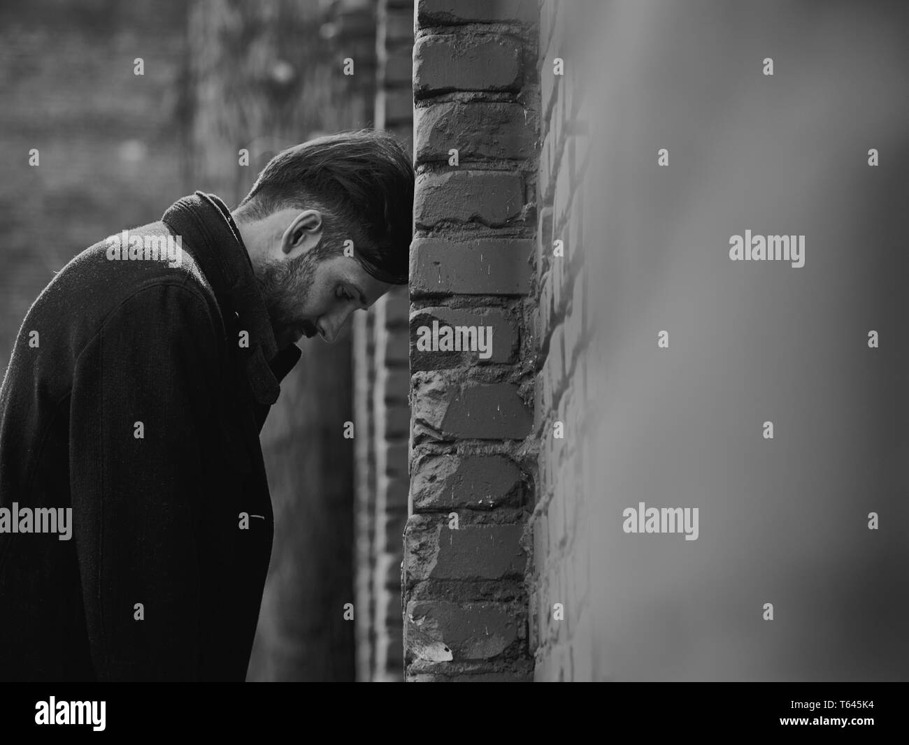 Frustrated Depressed Young Man Near The Brick Wall Looking Angry Closeup Sad Toned Dramatic Vintage Portrait Profile View Black And White Stock Photo Alamy