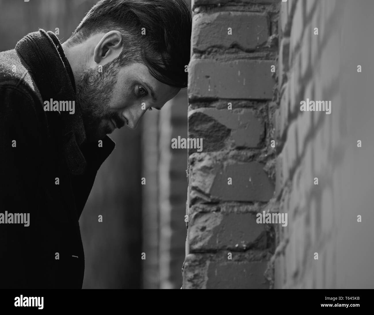 Frustrated Depressed Young Man Near The Brick Wall Looking Angry Closeup Sad Toned Dramatic Vintage Portrait Profile View Art Black And White Stock Photo Alamy