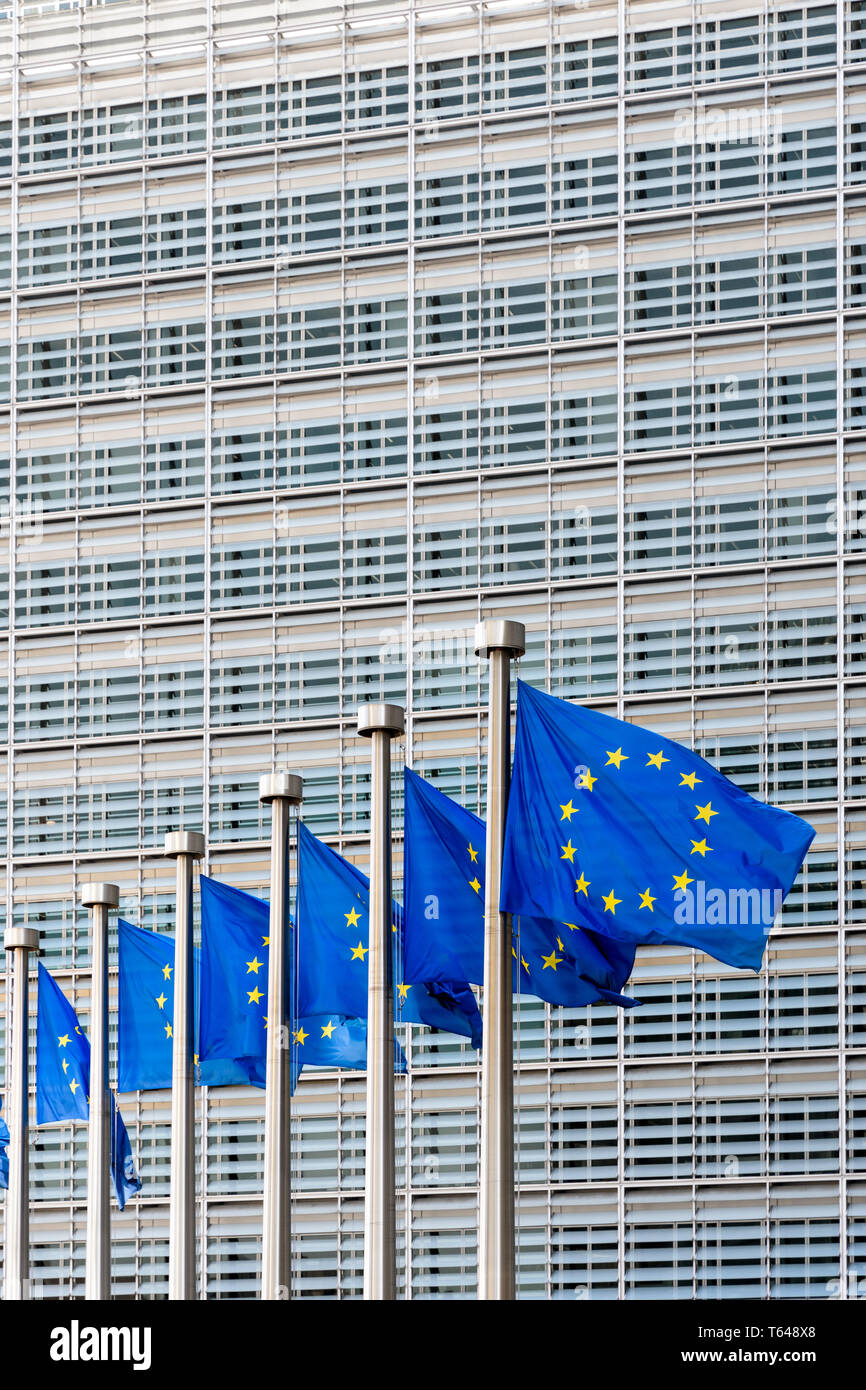 Flags of the European Union blowing in the wind in front of the Berlaymont building, headquarters of the European Commission in Brussels, Belgium. Stock Photo