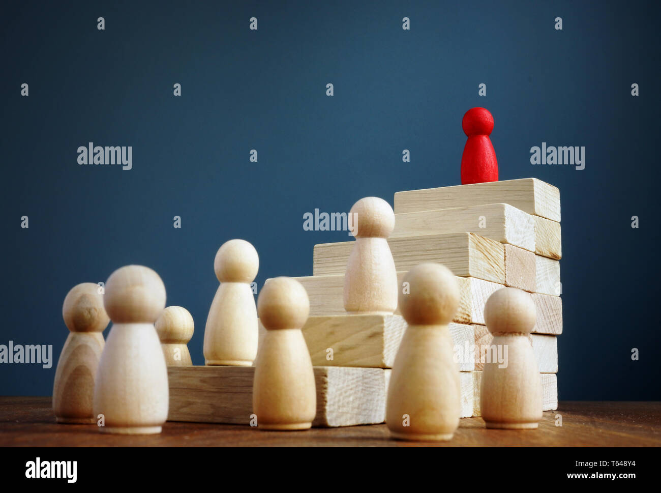 Career growth and development. Stairs from blocks and figurine as leader. Stock Photo