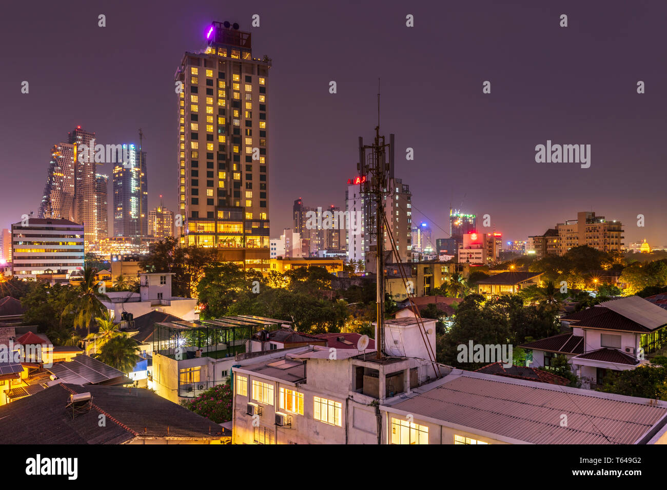 As the temperature cools in evening the skyline of Colombo, the capital city of Sri Lanka, lights up at dusk. Colombo is Sri Lanka's one true metropol Stock Photo