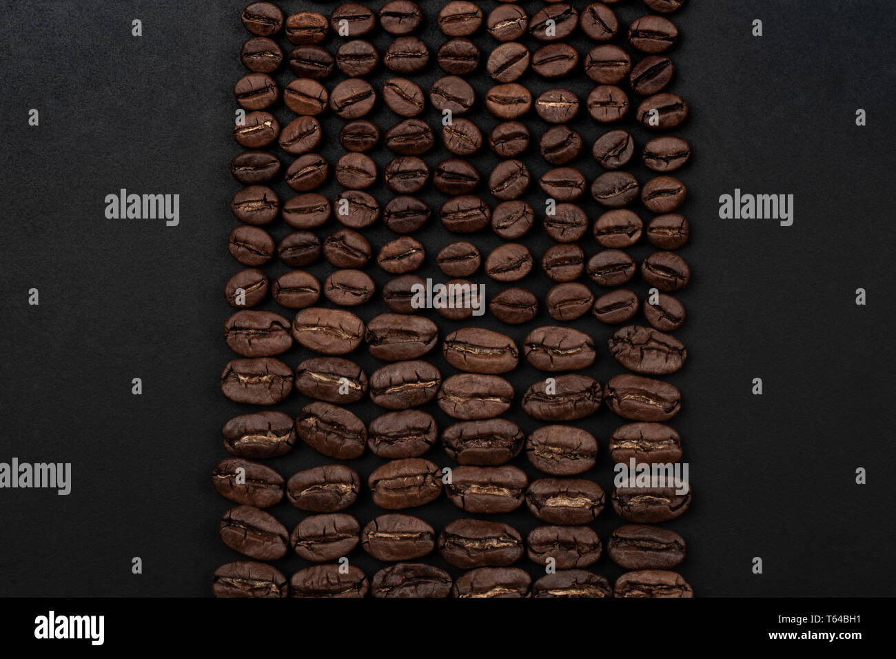 Roasted coffee beans on black background. Top view with space for your ...
