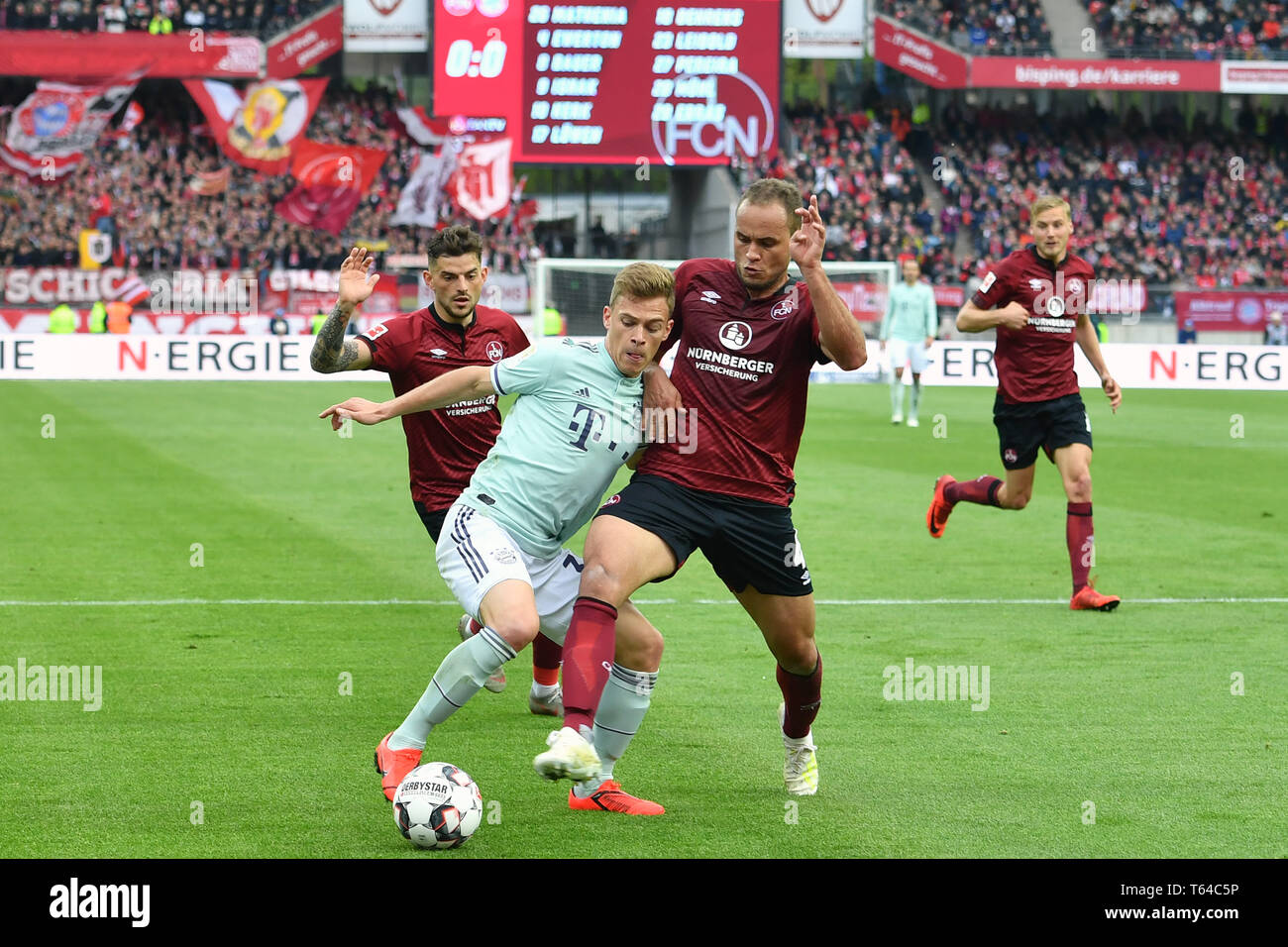 Nuremberg, Deutschland. 28th Apr, 2019. Joshua KIMMICH (FC Bayern Munich)  comes to fall versus EWERTON (1.FC Nuremberg), action, duels. Box scene.  Soccer 1. Bundesliga, 31.matchday, matchday31, 1.FC Nuremberg (N) -FC Bayern  Munich (