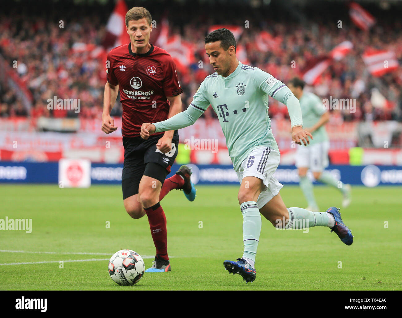 Nuremberg, Germany. 28th Apr, 2019. Bayern Munich's Thiago (R) competes during a German Bundesliga match between 1.FC Nuremberg and FC Bayern Munich in Nuremberg, Germany, on April 28, 2019. The match ended 1-1. Credit: Philippe Ruiz/Xinhua/Alamy Live News Stock Photo