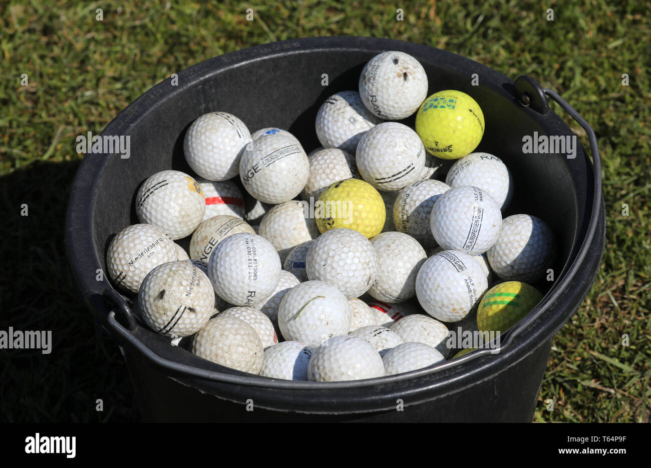 Golf balls and bucket hi-res stock 