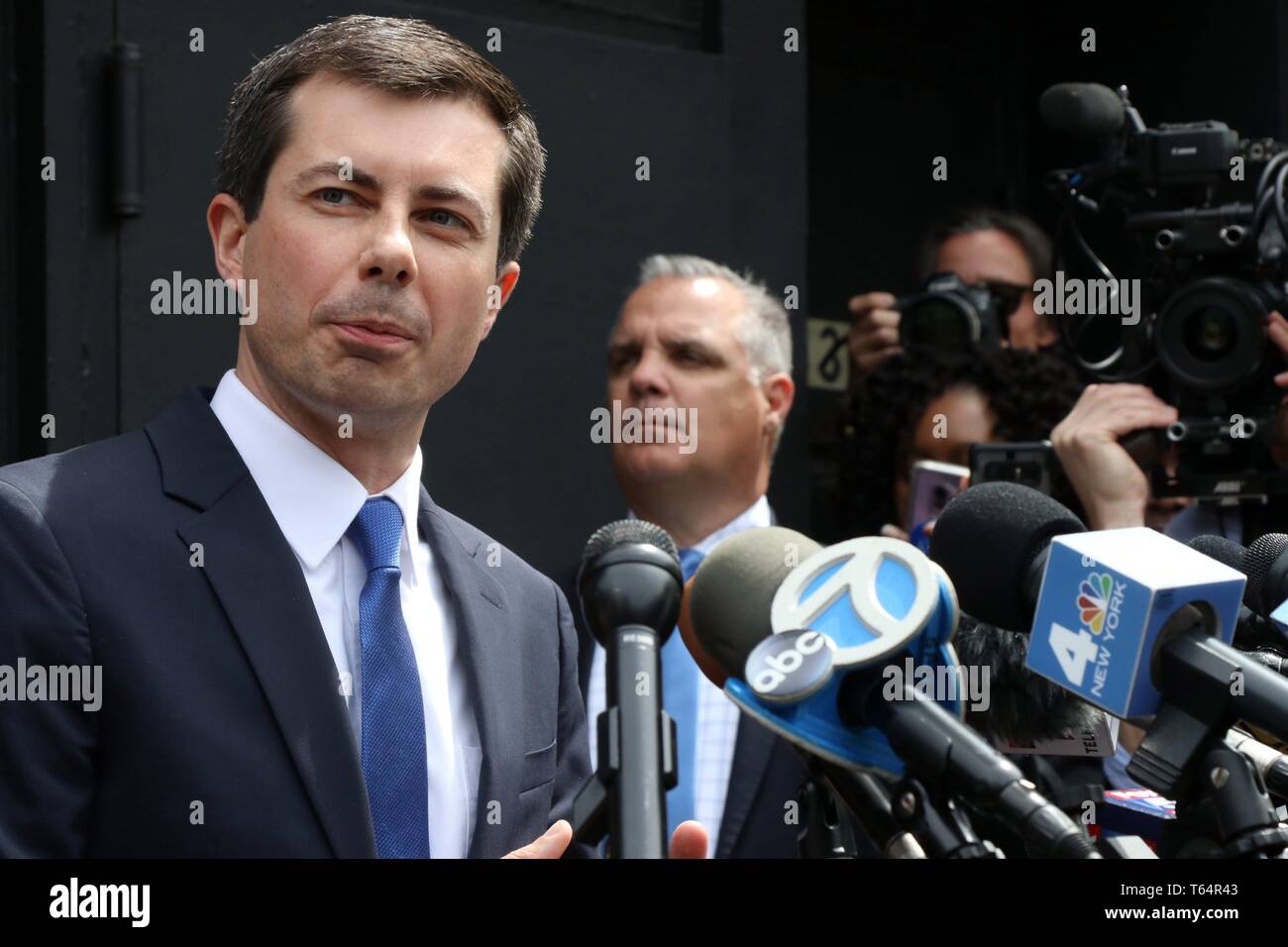 New York City, New York, USA. 29th Apr, 2019. Rev. Al Sharpton hosted Mayor Pete Buttigieg for.lunch at Sylvia's, the historic Harlem establishment on 29 April, 2019, the venue where Rev. Sharpton has hosted several candidates at over the years. Immediately following the lunch, Rev. Sharpton and Mayor Buttigieg held a media conference outside the restaurant. Pictured is Mayor Buttigieg and Rev. Al Sharpton speaking to media outside of Sylvia's restaurant. Credit: G. Ronald Lopez/ZUMA Wire/Alamy Live News Stock Photo