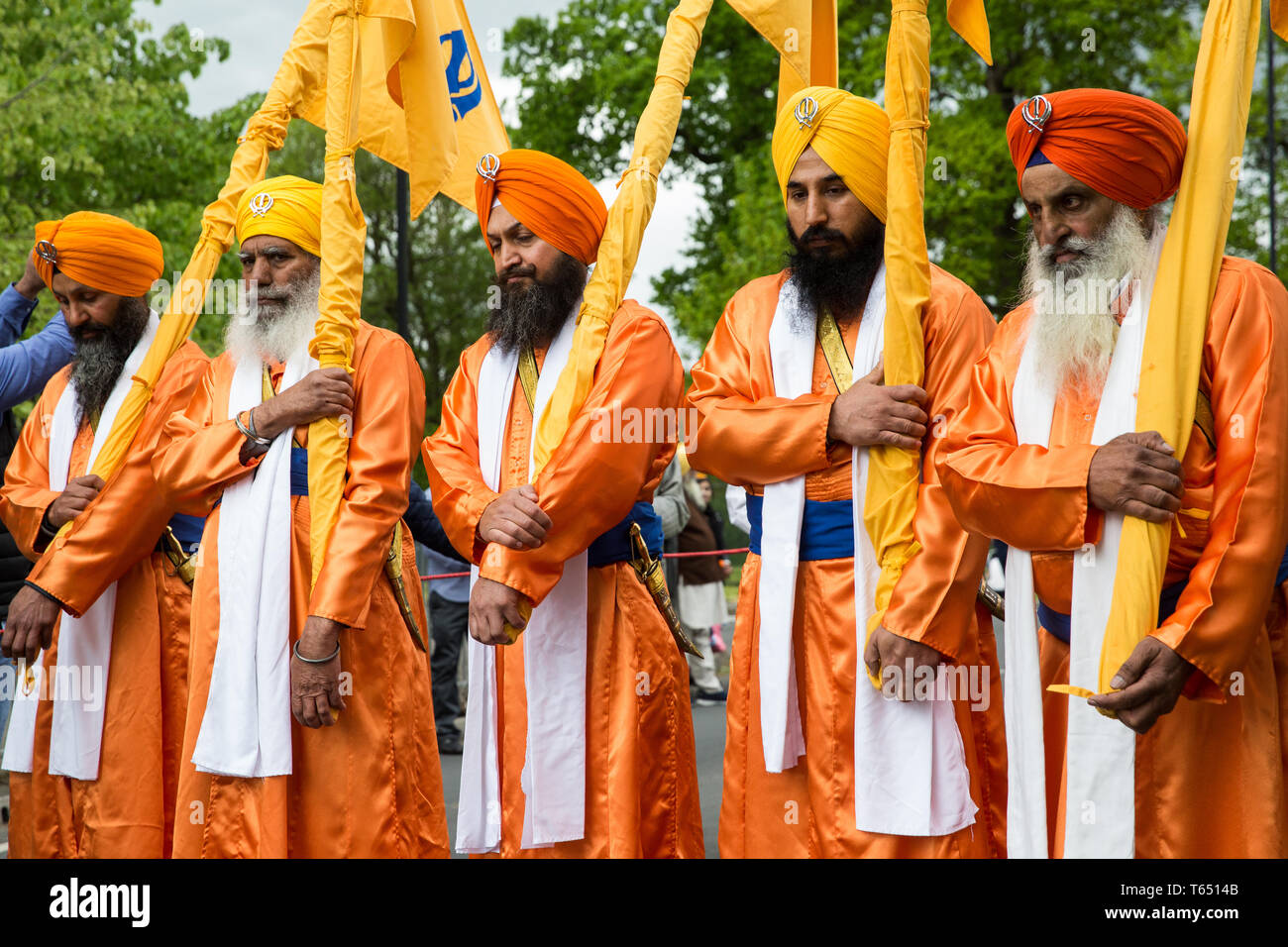Slough, UK. 28th April 2019. The bearers of the Nishan Sahib take part in the Vaisakhi Nagar Kirtan procession from the Gurdwara Sri Guru Singh Sabha  Stock Photo