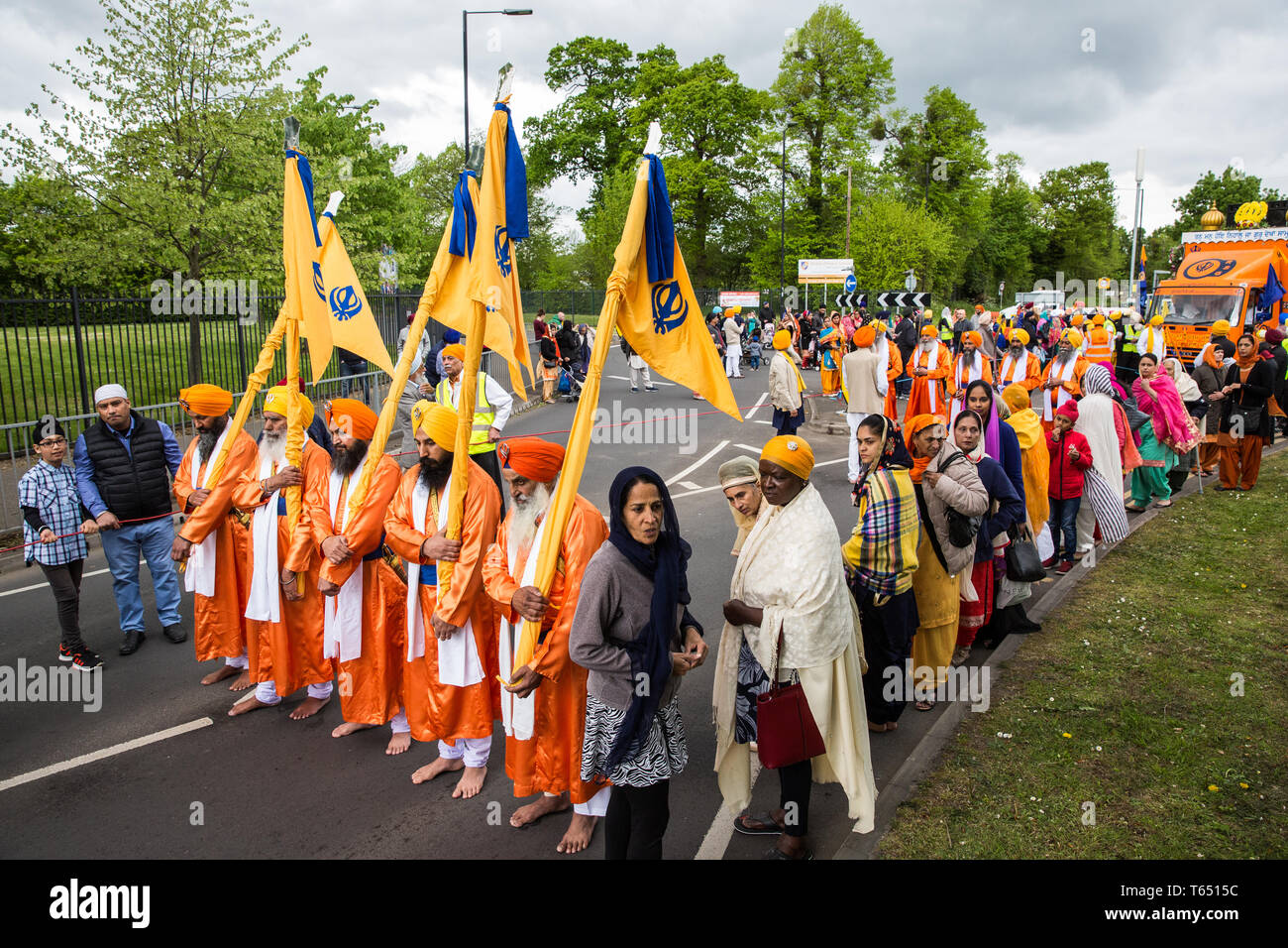 Slough, UK. 28th April 2019. The bearers of the Nishan Sahib, followed by the Pani Pyare (Five Beloved Ones), take part in the Vaisakhi Nagar Kirtan p Stock Photo