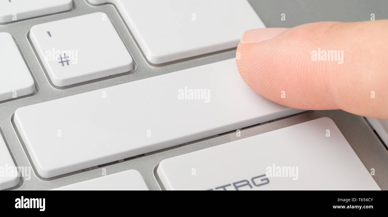 A finger clicking an unlabeled button on a keyboard Stock Photo Alamy