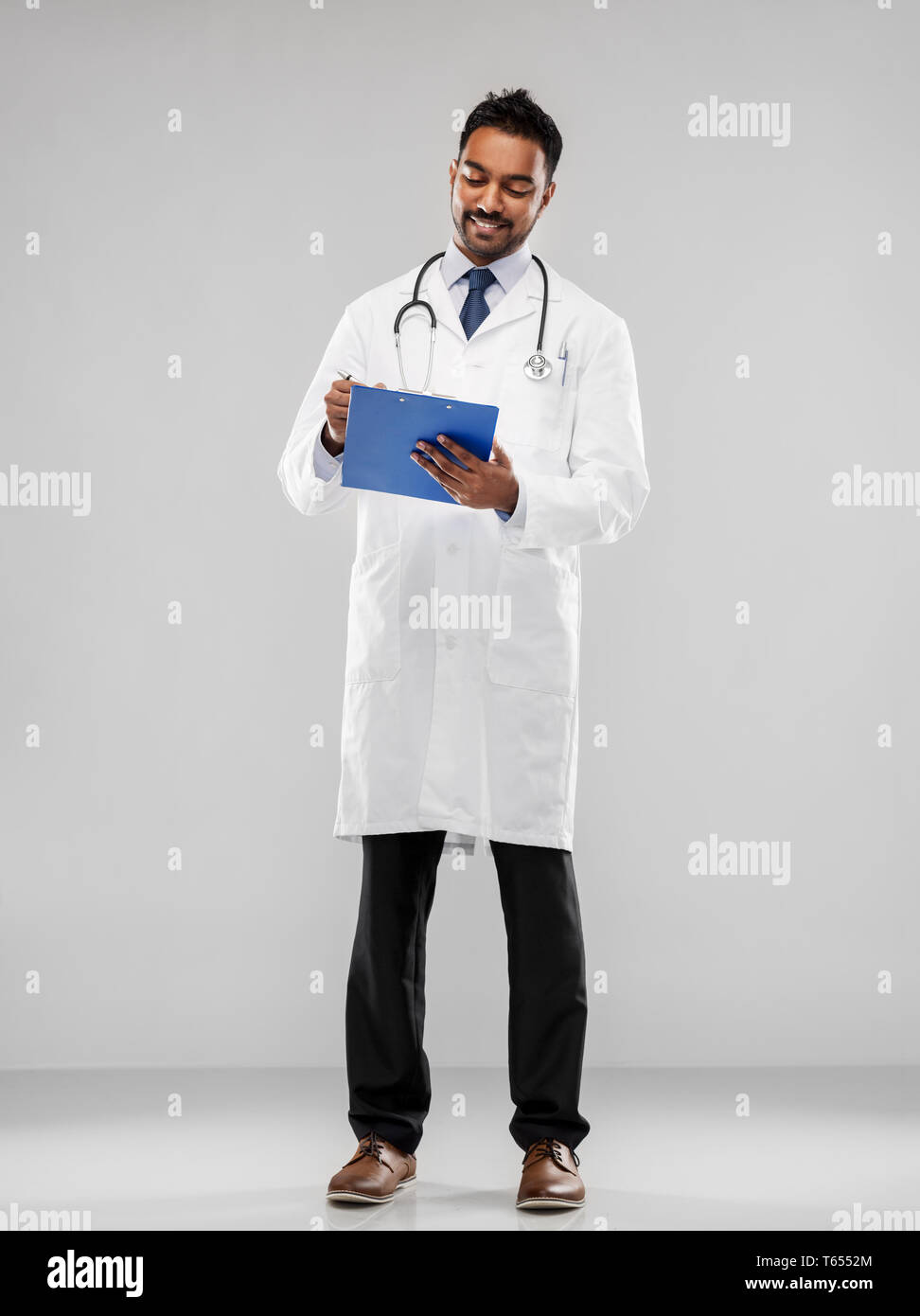 indian male doctor with clipboard and stethoscope Stock Photo - Alamy