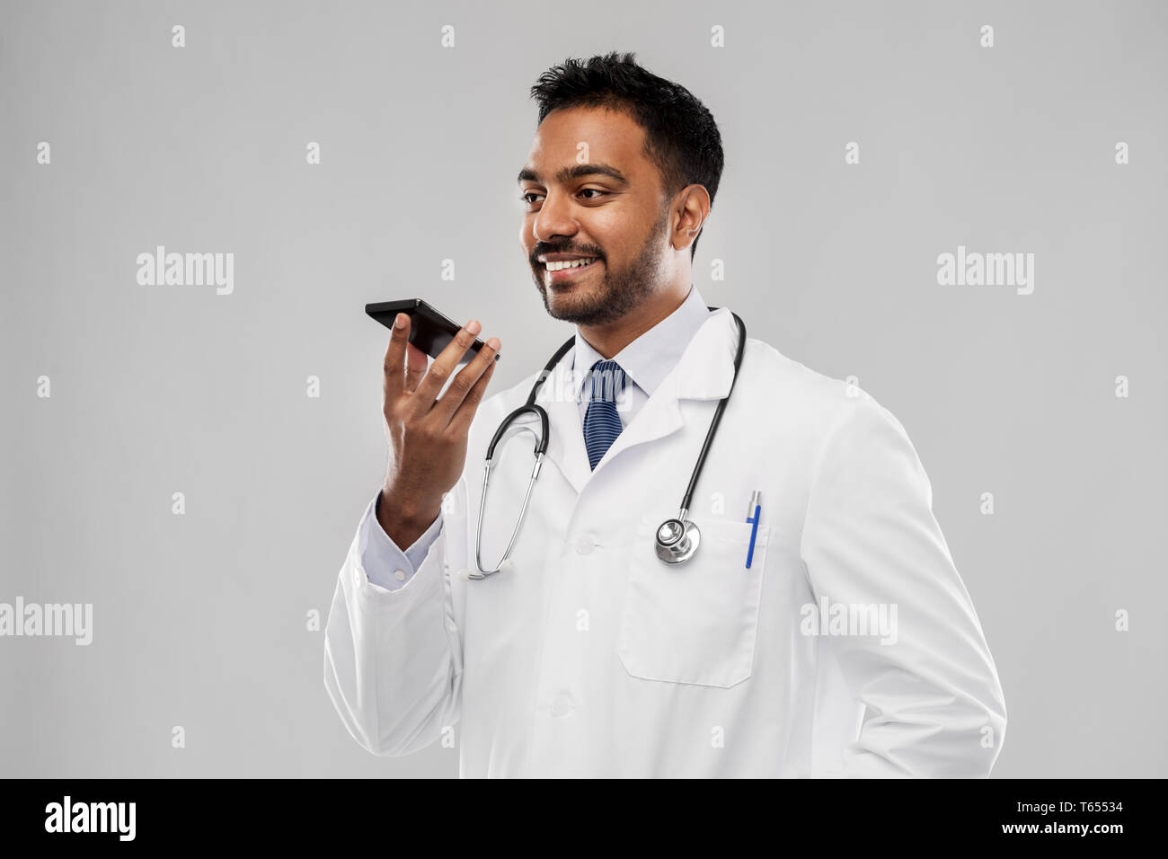 Indian male doctor using mobile hi-res stock photography and images - Alamy
