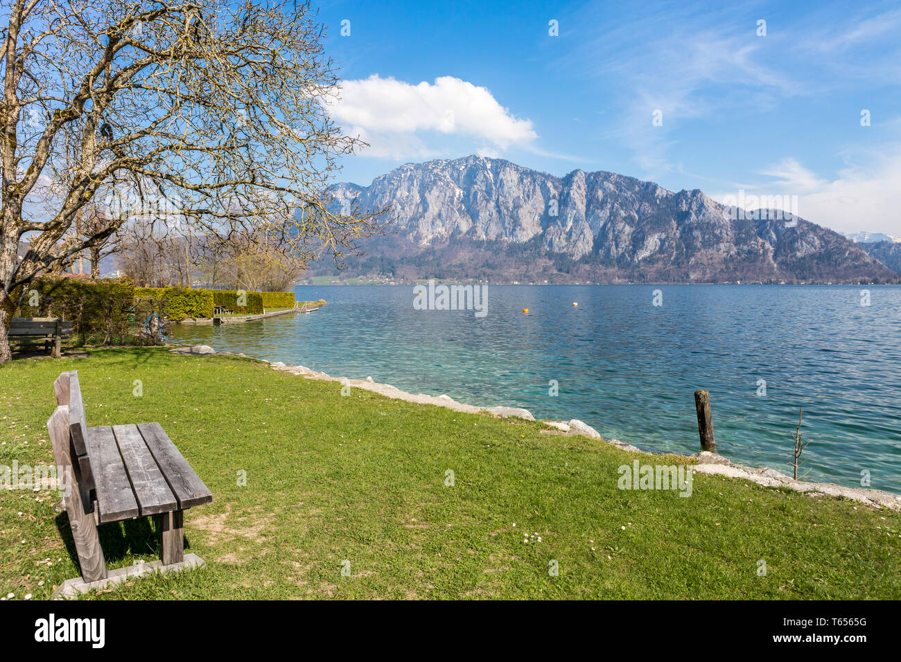 Wooden bench overlooking Lake Attersee, Salzkammergut, Austria Stock Photo