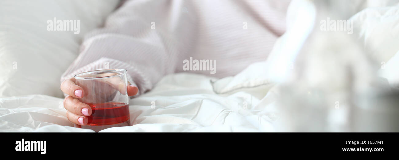 Young woman lying in bed deadly drunken Stock Photo