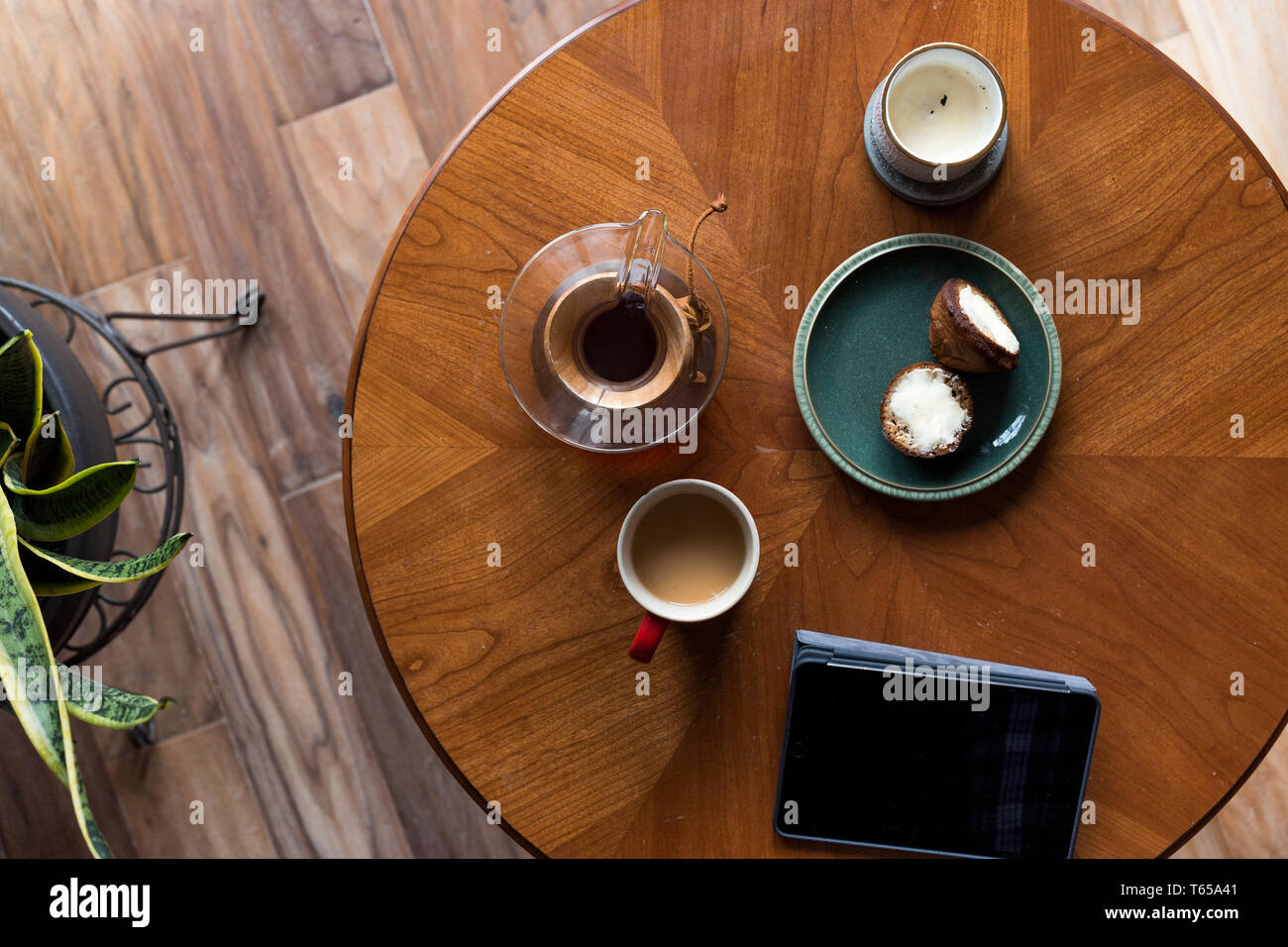 A top down shot of modern living room coffee table with a coffee cup