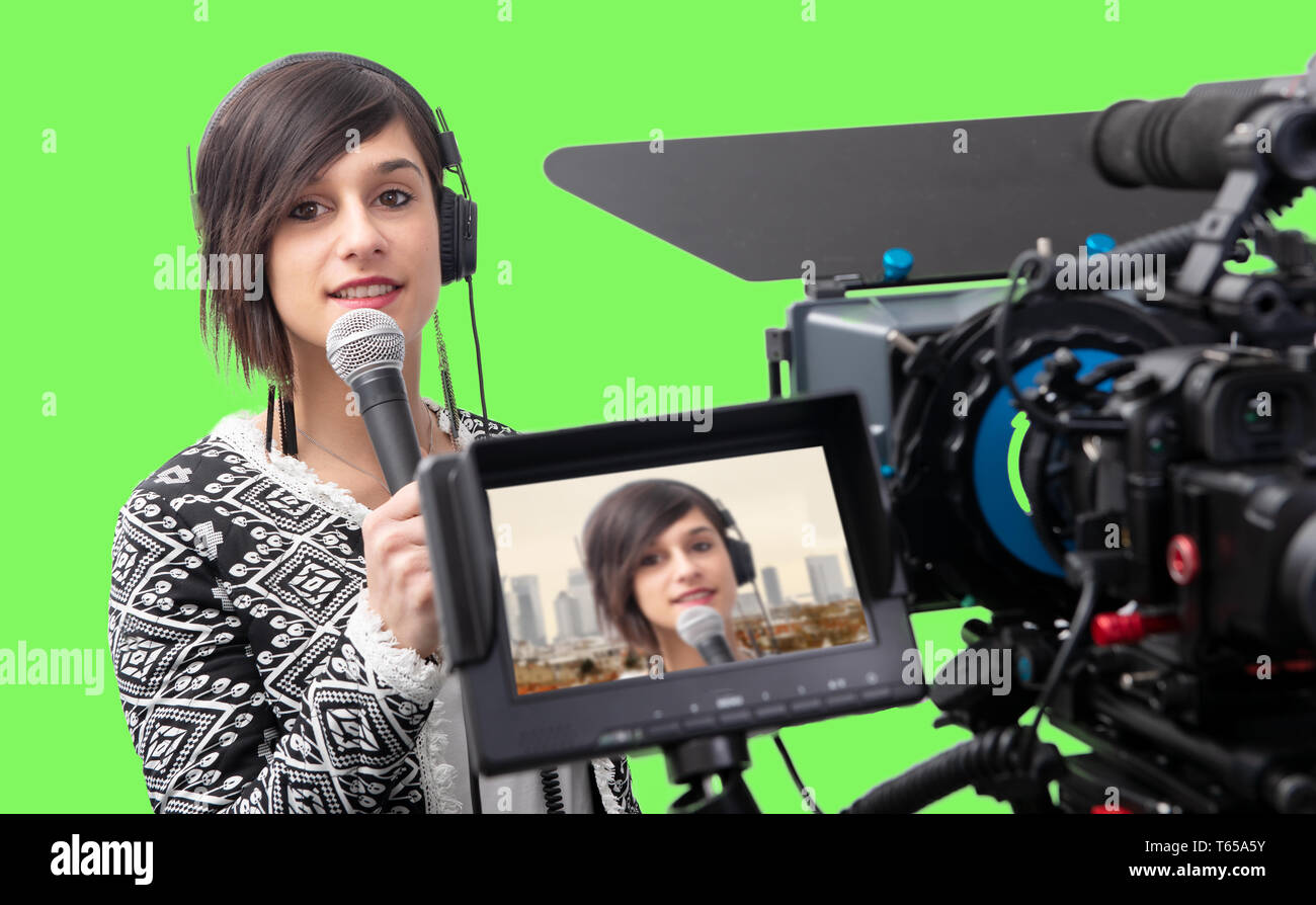 pretty young woman  journalist presenting report in television studio on green screen Stock Photo