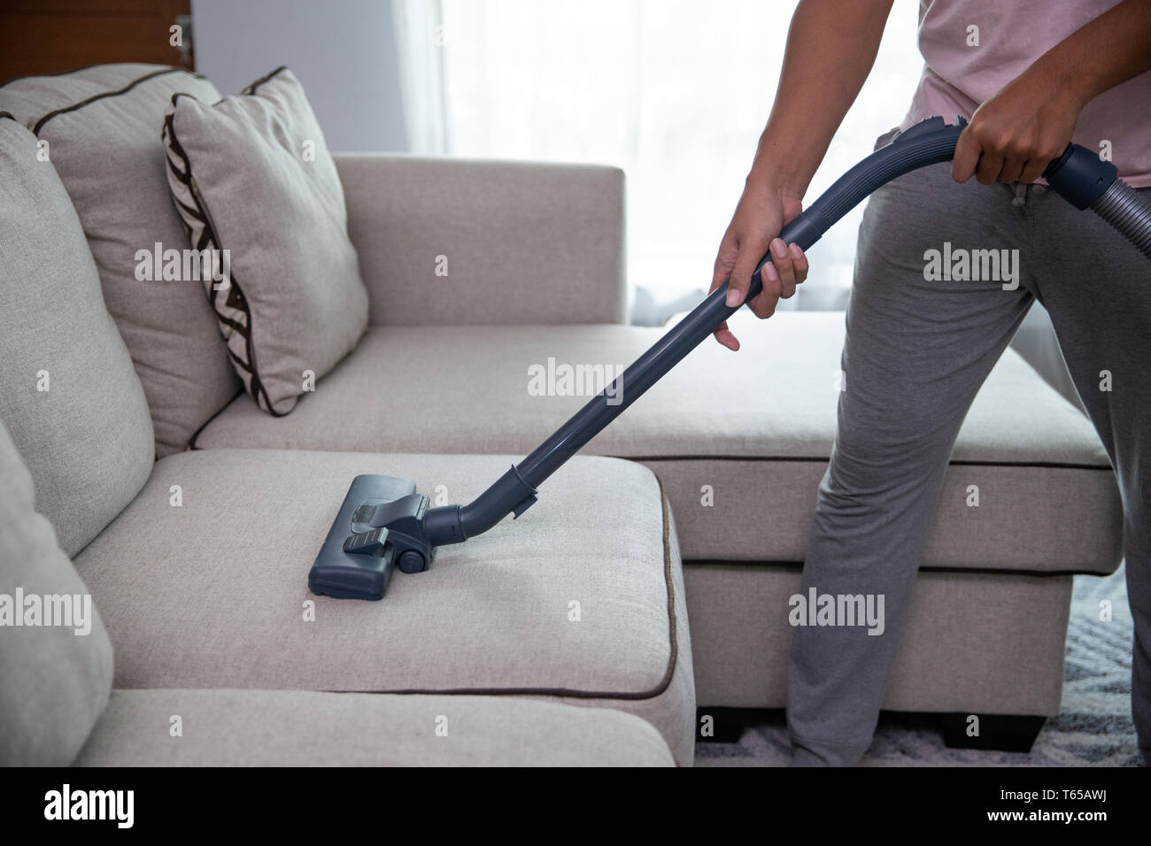 man using vacuum cleaner Stock Photo - Alamy