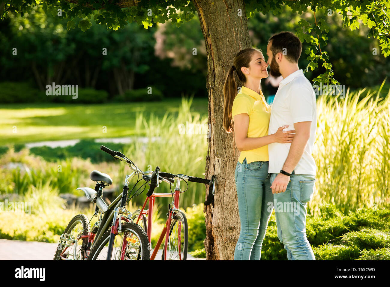 Young couple is kissing on summer nature background. Stock Photo