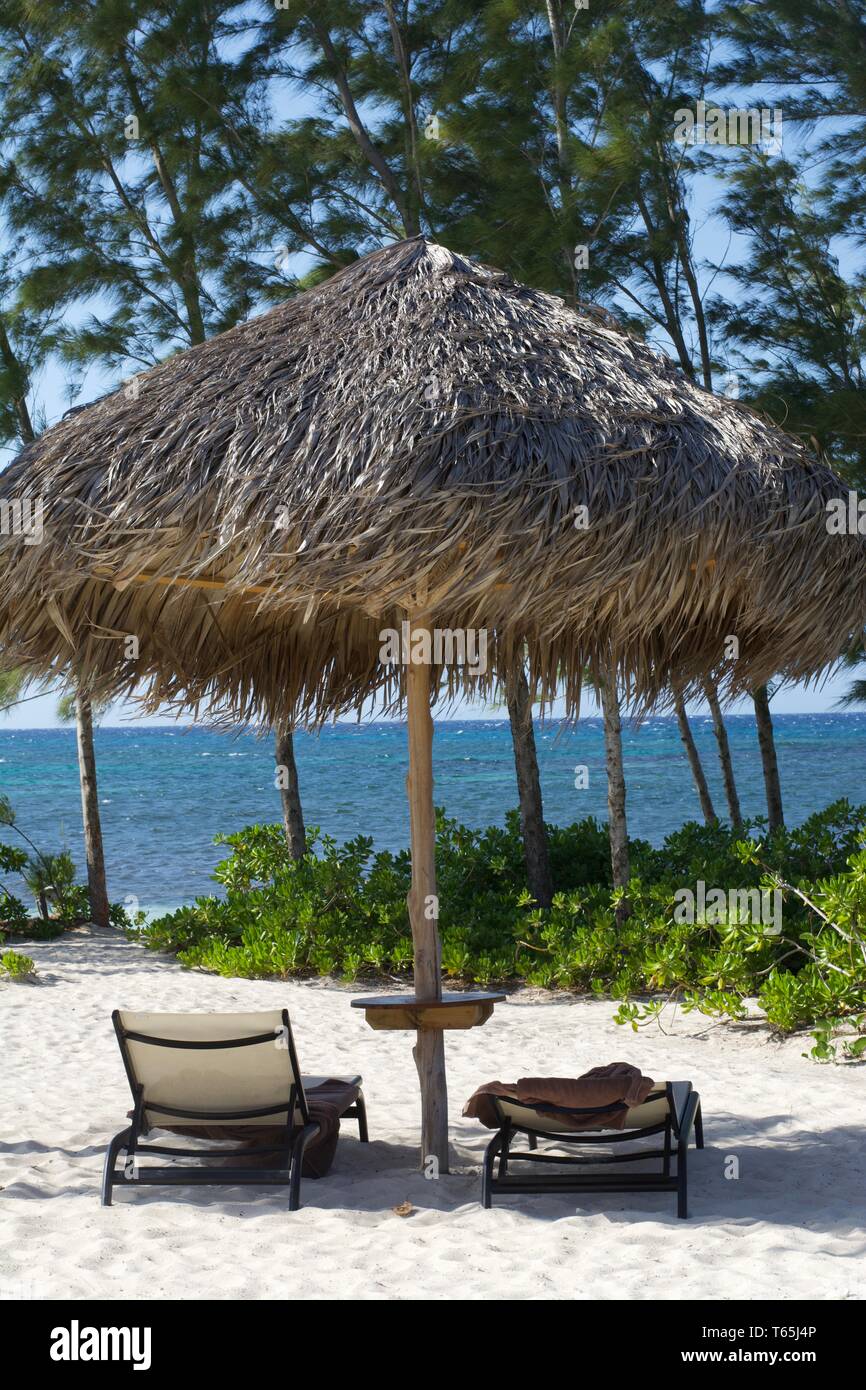 Chairs and tiki on beach in Montego Bay, Jamaica Stock Photo