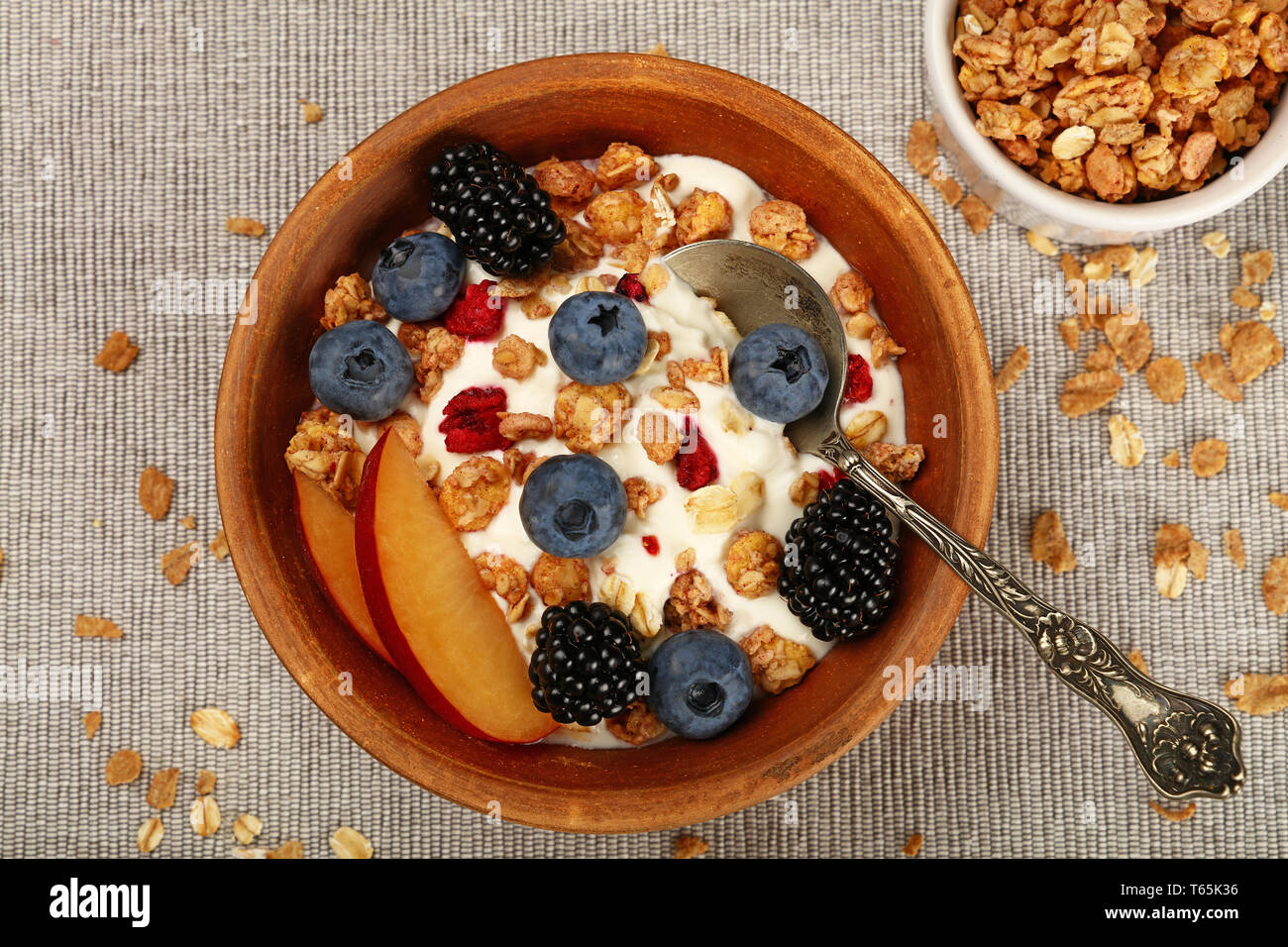 yogurt with fresh garden berries and cereals in reusable picnic