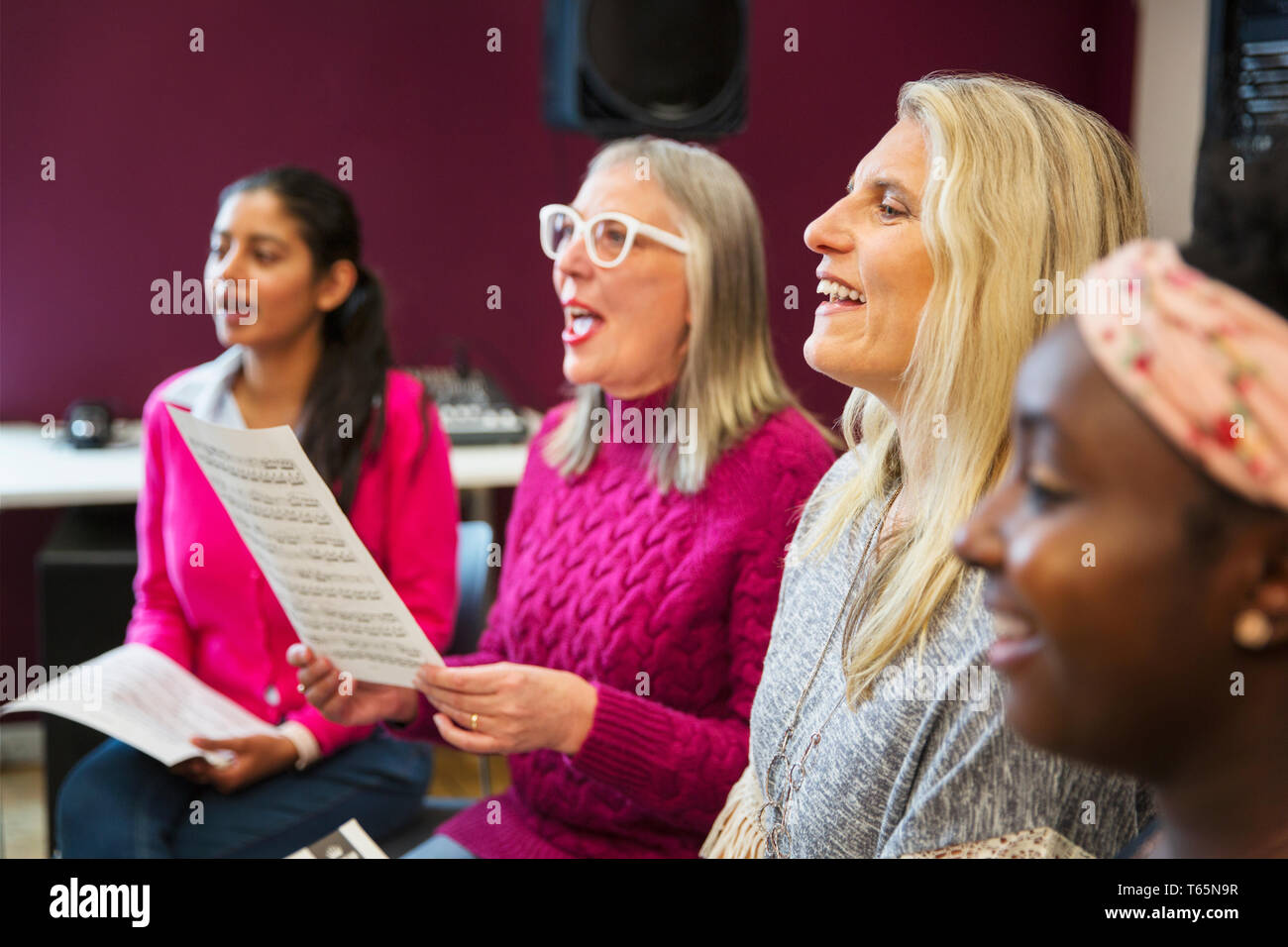 Womens choir singing in music recording studio Stock Photo